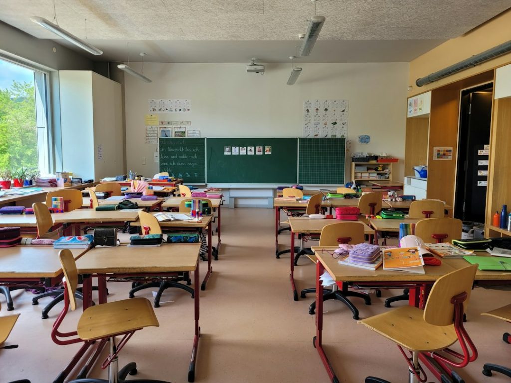 Sală de clasă cu bănci de școală