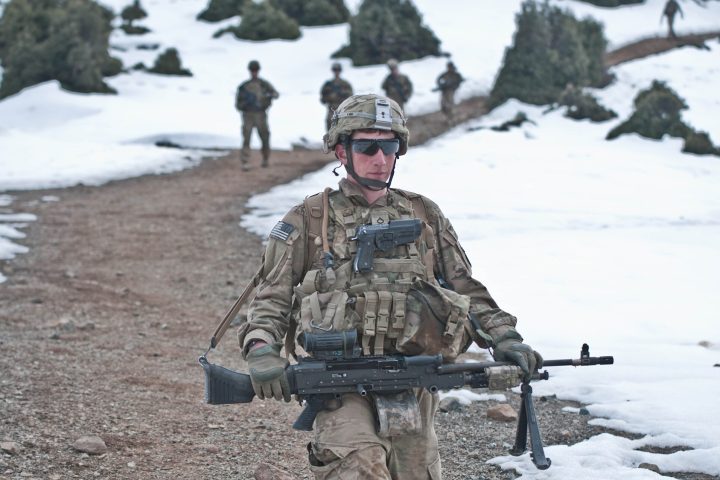U.S. Army Pfc. Cristian Franco, assigned to 3rd Battalion, 509th Infantry Regiment, carries an M240B machine gun while descending a mountain path during a secur